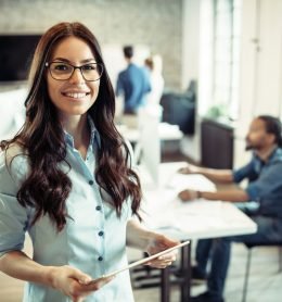 Young attractive female architect working in modern office